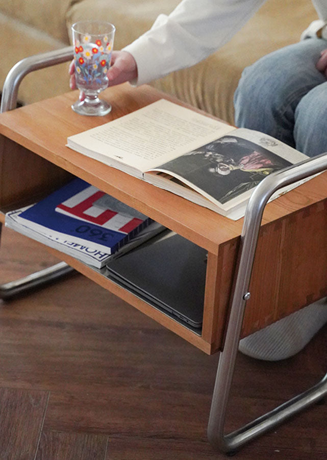 The Cadre Solid Wood and Stainless Steel bench as a side table.