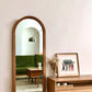 Apli Solid Cherry Wood Full-Length Mirror, hung on the wall.