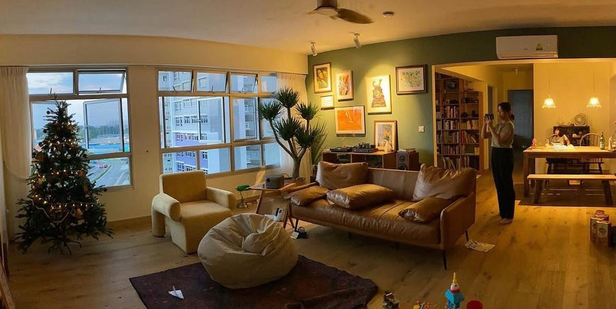 Our living room in Singapore with a leather sofa, solid wood shelving and bookcase