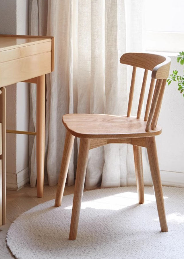 A broad-backed Solid Oak Windsor Chair