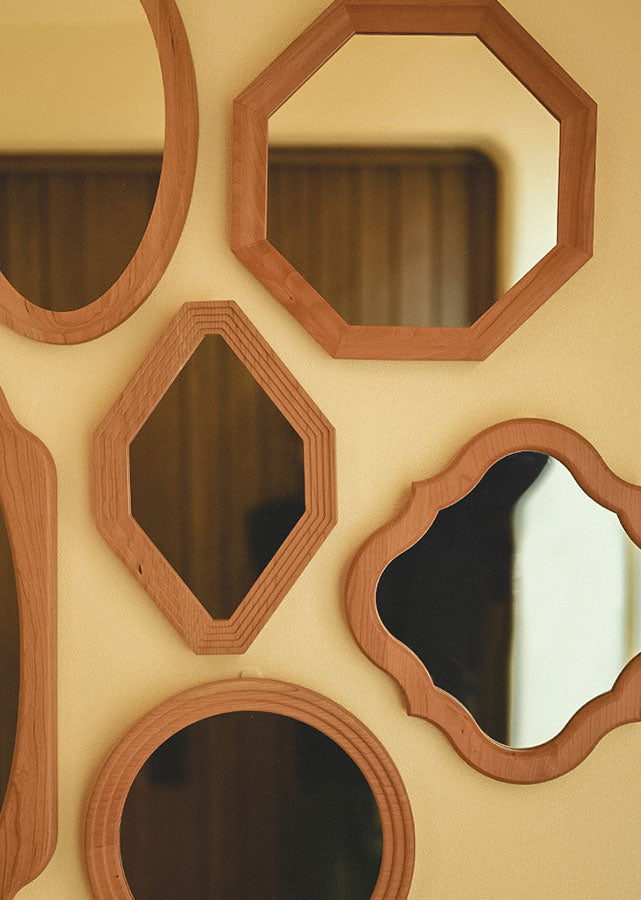 The Certa Solid Wood Geometrical Mirror is small on its own, but can form a decorative wall when used as a group.