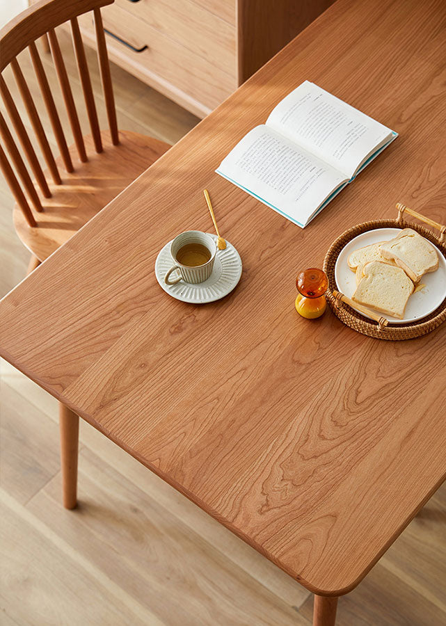 Close up of solid cherry wood grains of solid wood table.